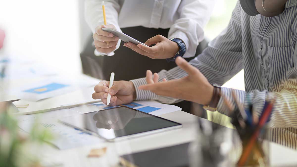 Two designers work collaboratively on a design concept.